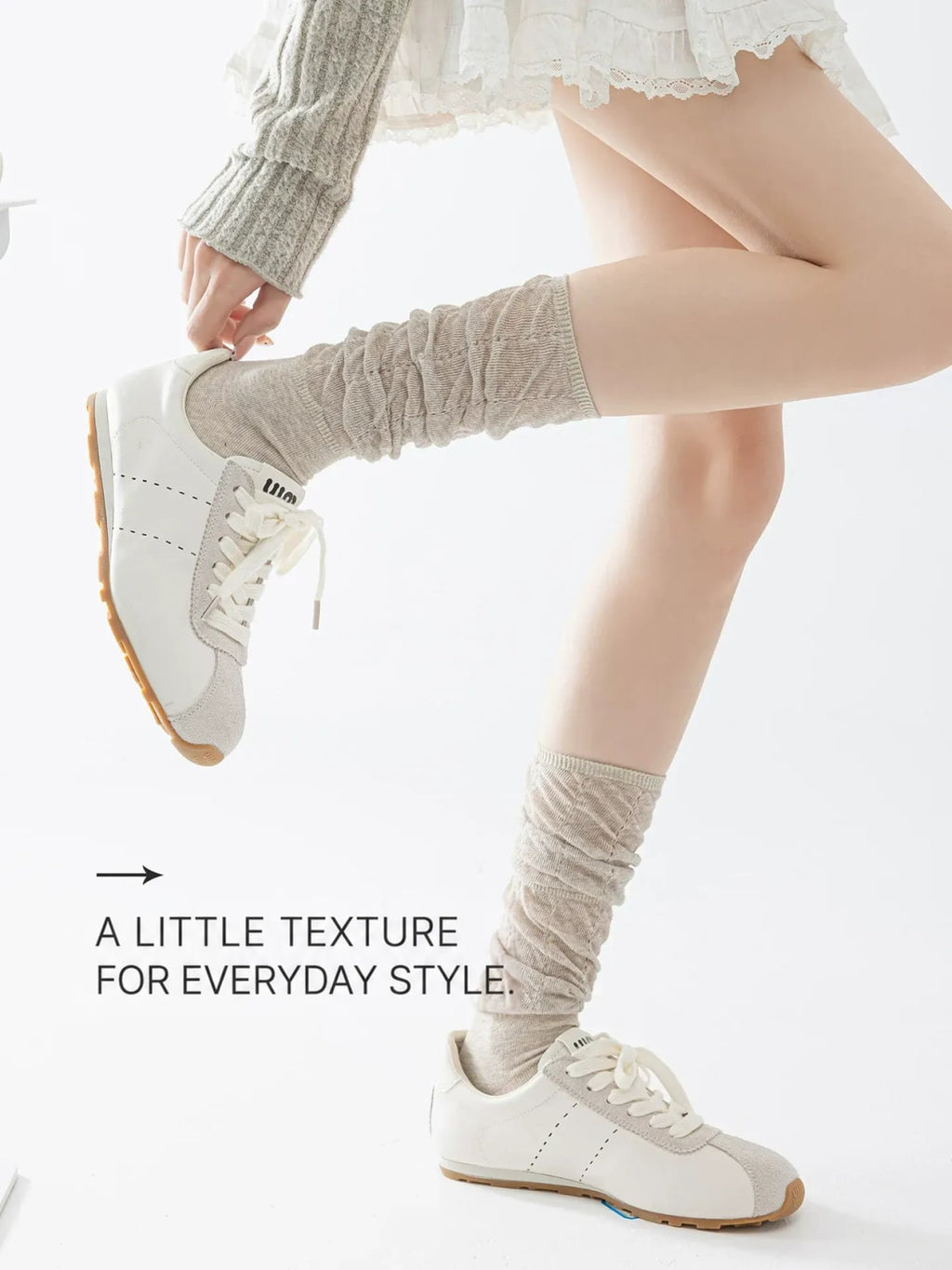 Khaki slouch calf socks styled with cream sneakers