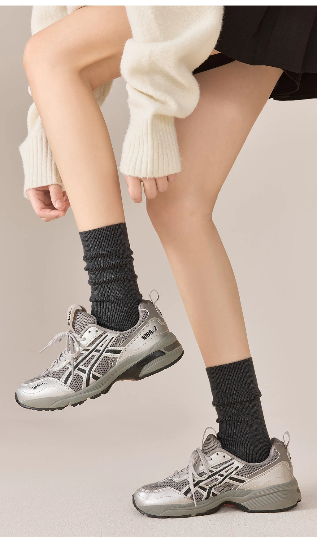 Dark gray crew socks with sneakers, full-length styling